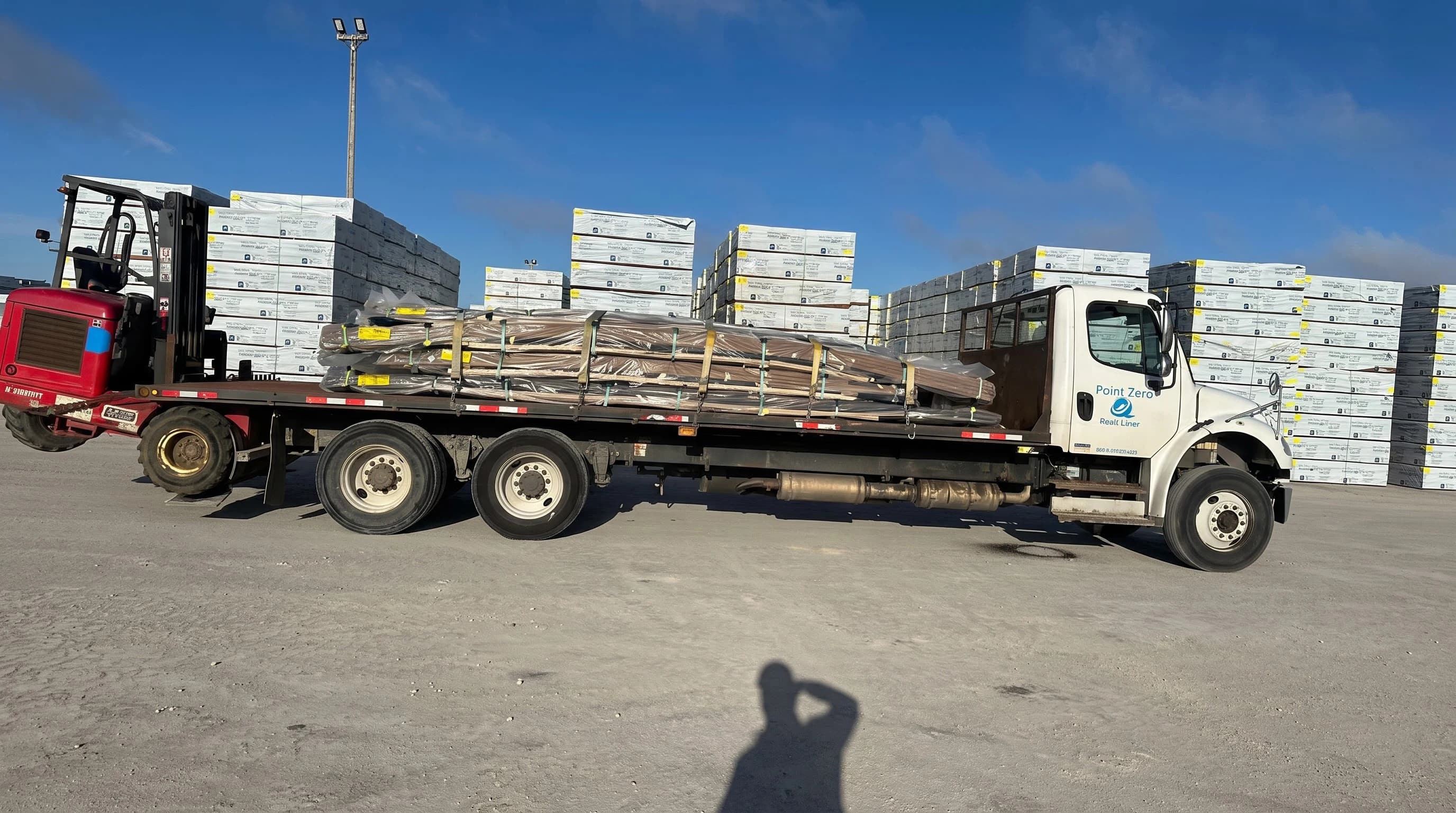 Point Zero Road Lines flatbed unloading on construction site